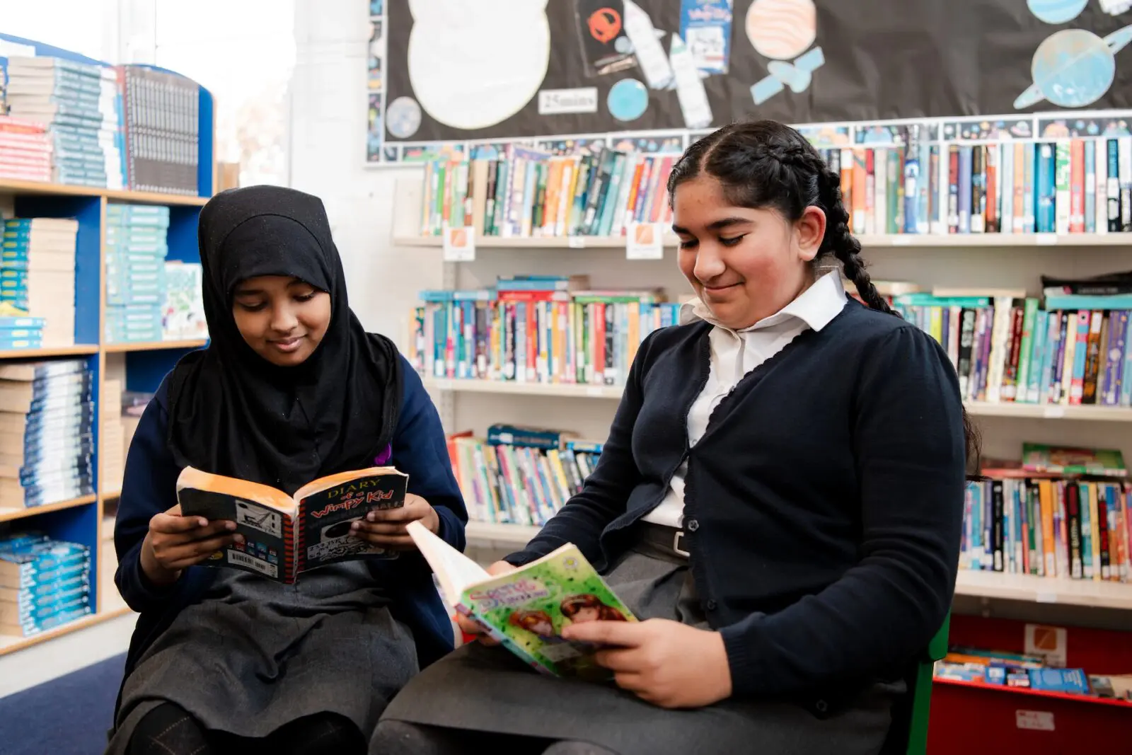 Girls reading in library